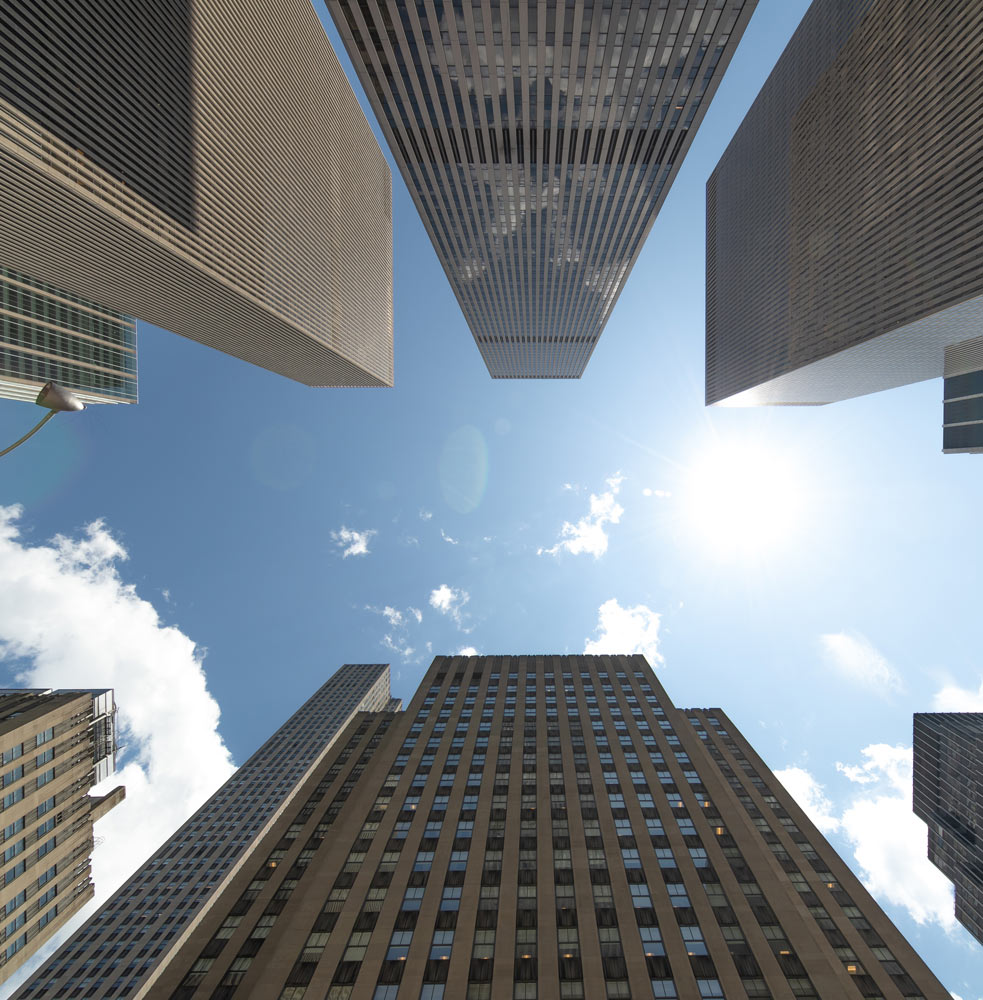 Looking up at highrise builldings in a city