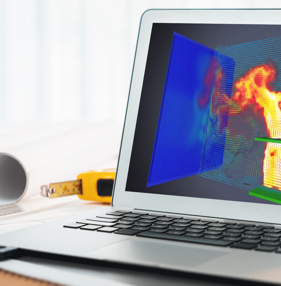 Architecture elements on desk with computer showing fire map