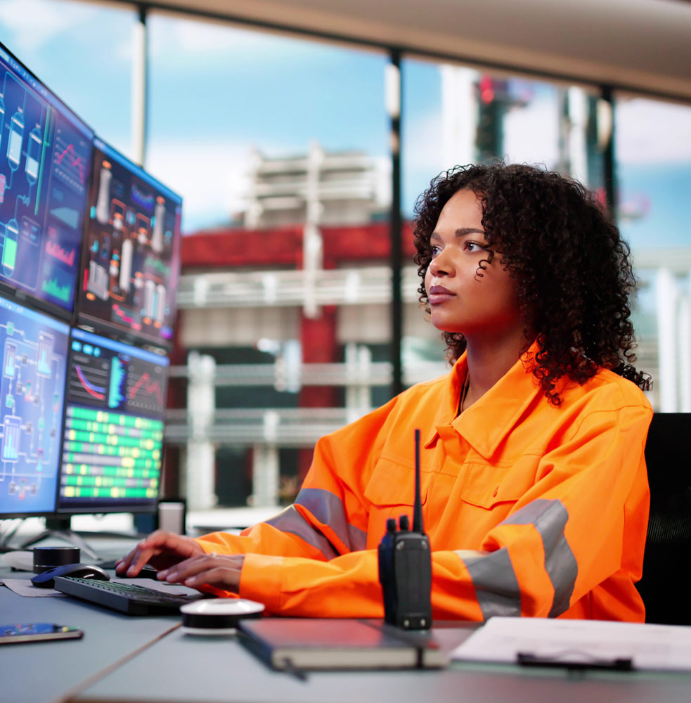 Woman on a series of computer screens monitoring smoke system in building