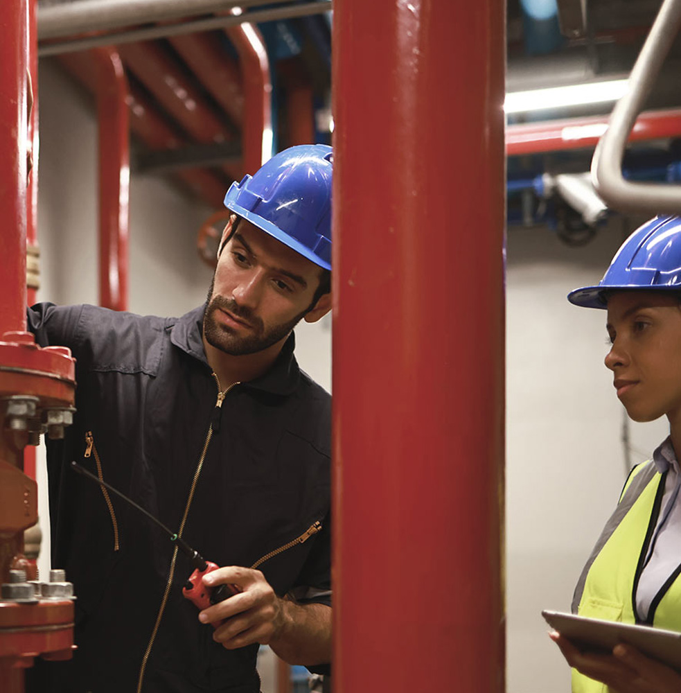 Two engineers troubleshooting sprinkler system