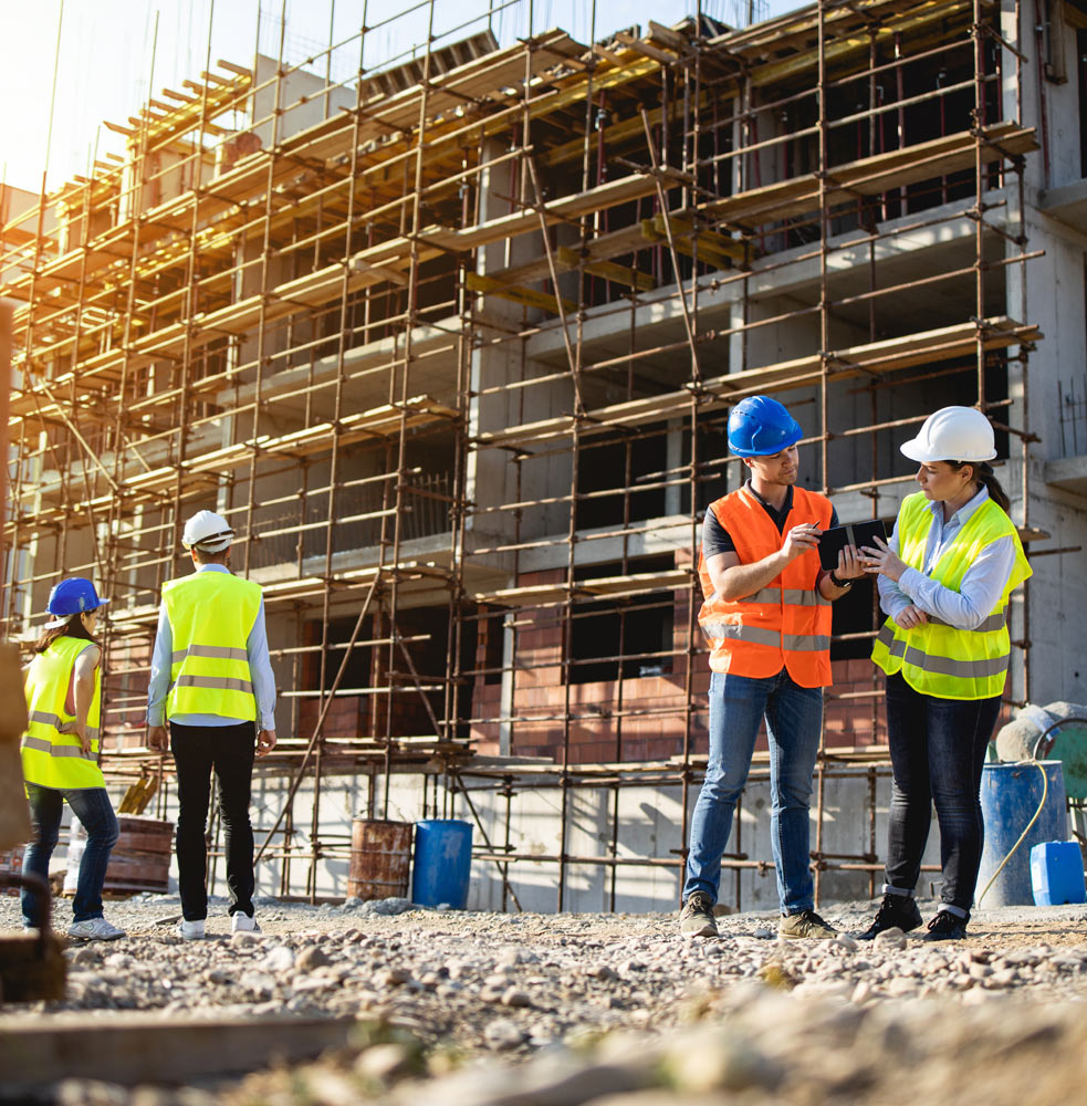 Construction workers discussion outside building construction